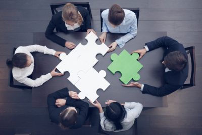 Business people assembling puzzle