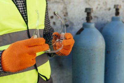 worker-with-gloves-holding-protective-glasses